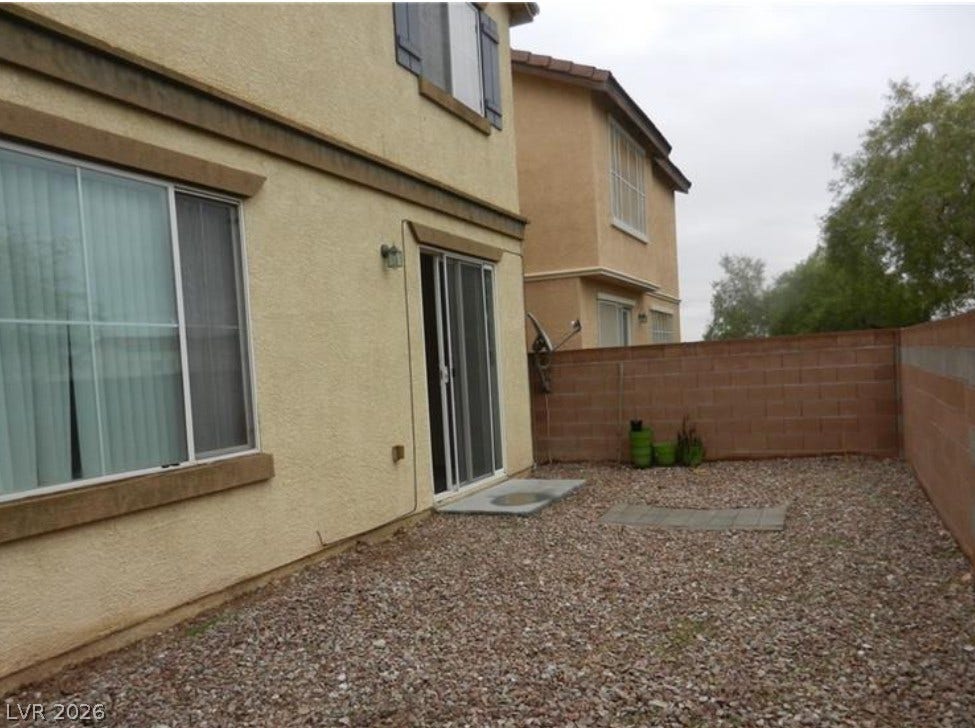 4421 Oberlander Avenue, North Las Vegas, NV 89031 A gravel-landscaped rear yard is enclosed by a privacy wall.