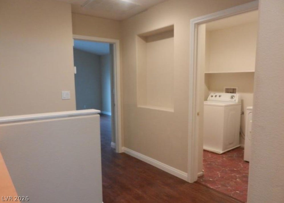 4421 Oberlander Avenue, North Las Vegas, NV 89031 Rich wood-inspired flooring connects the hallway to a dedicated laundry space with built-in shelving.