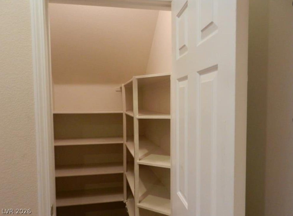 4421 Oberlander Avenue, North Las Vegas, NV 89031 Ample built-in shelving maximizes storage potential underneath the staircase structure.