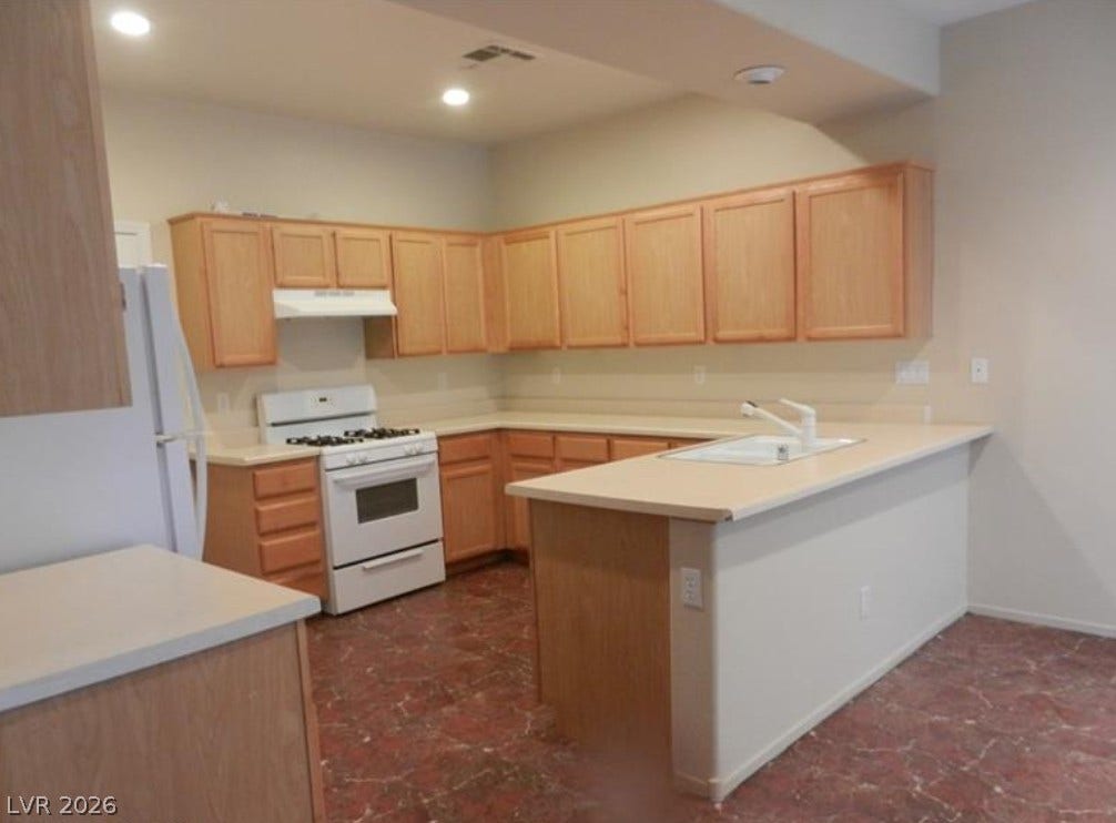 4421 Oberlander Avenue, North Las Vegas, NV 89031 Ample wooden cabinetry and resilient flooring define this functional cooking space.