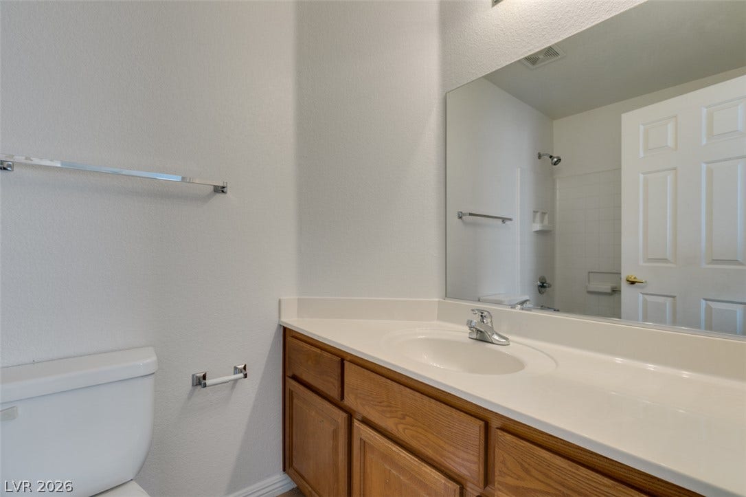 3612 Indigo Flower Street, #2, North Las Vegas, NV 89084 A classic wooden vanity anchors this tidy guest bathroom.