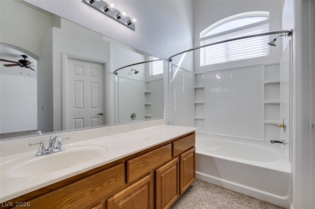 3612 Indigo Flower Street, #2, North Las Vegas, NV 89084 High ceilings and an arched window elevate this classic bathroom featuring a soaking tub.