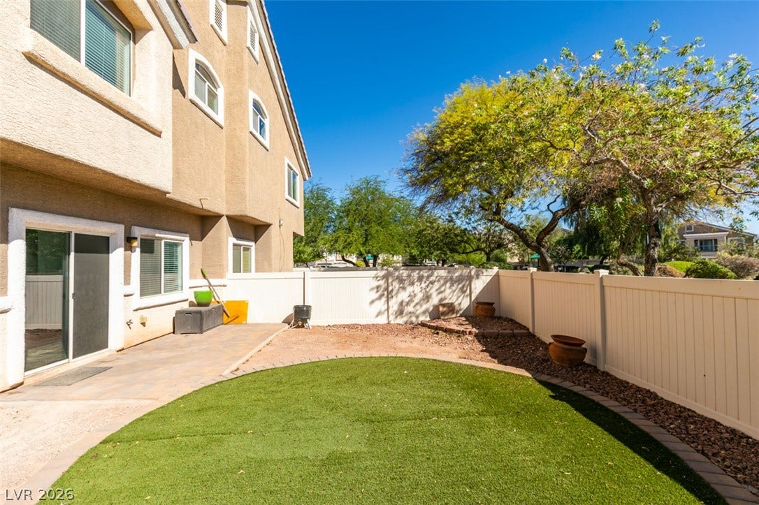 3612 Indigo Flower Street, #2, North Las Vegas, NV 89084 An enclosed backyard features low-maintenance synthetic turf and a paved patio area.