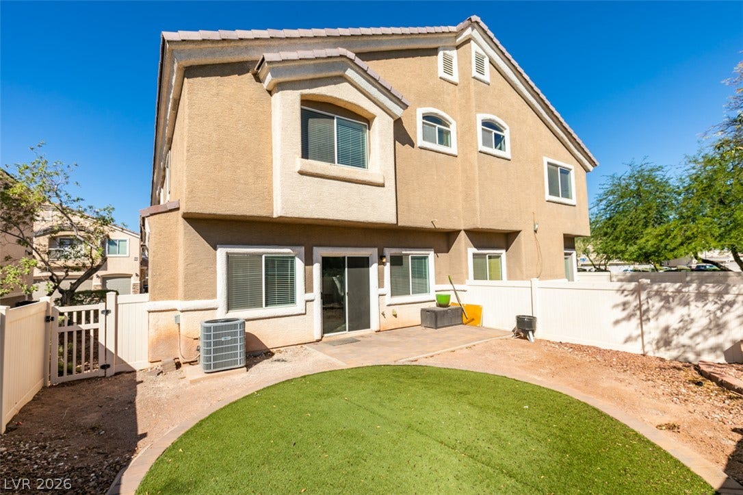 3612 Indigo Flower Street, #2, North Las Vegas, NV 89084 A private fenced backyard features a patio area and a low-maintenance circular green lawn.