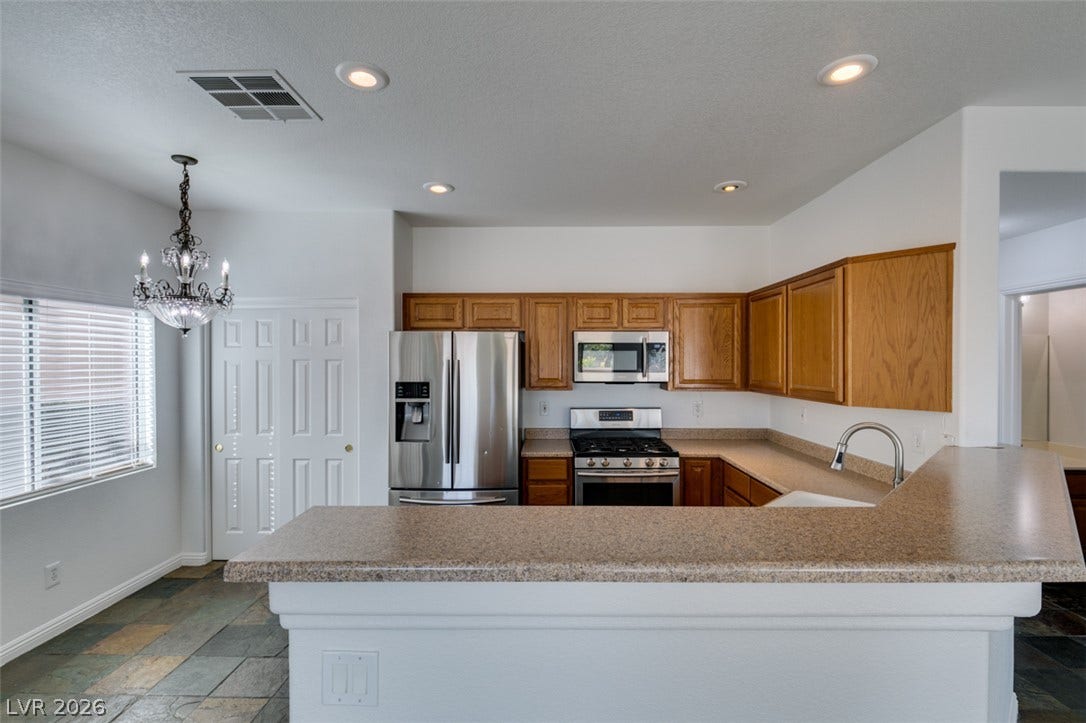 3612 Indigo Flower Street, #2, North Las Vegas, NV 89084 Rich wood cabinetry paired with ample counter space creates a highly functional culinary workspace.