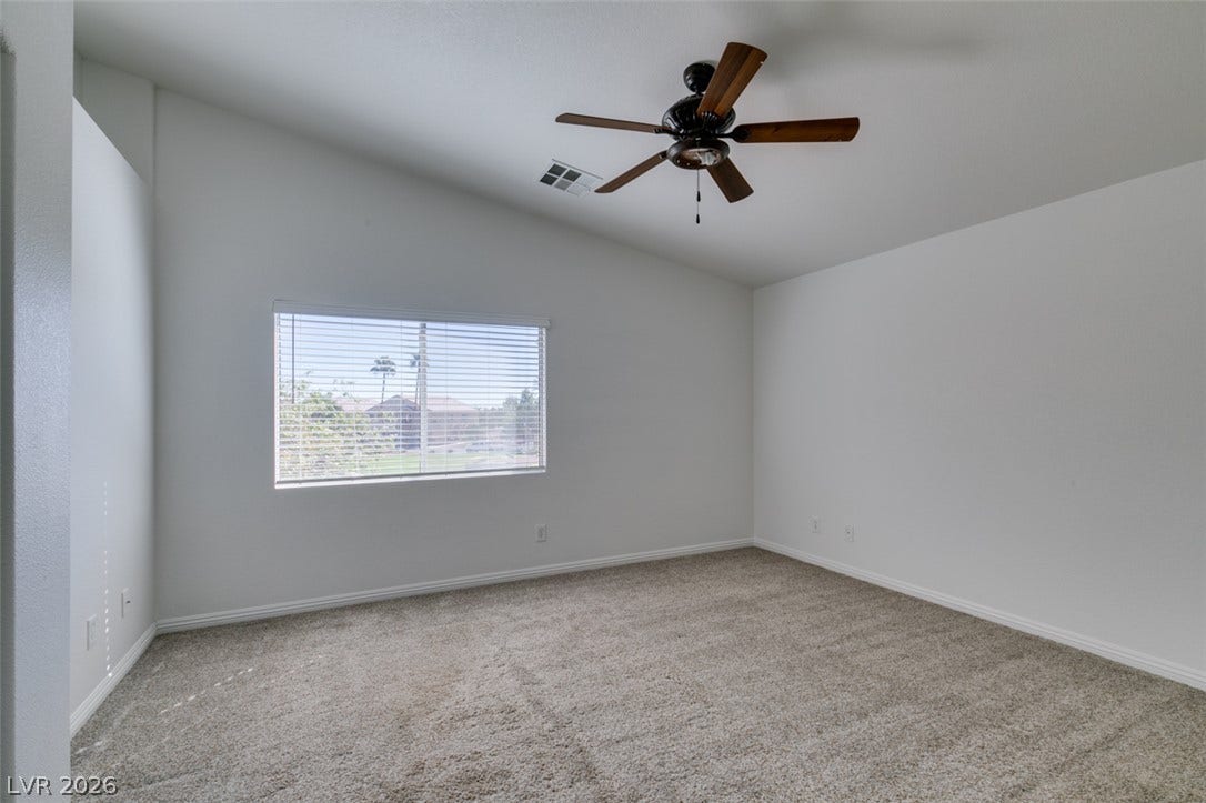 3612 Indigo Flower Street, #2, North Las Vegas, NV 89084 A spacious bedroom features neutral carpeting and high vaulted ceilings.