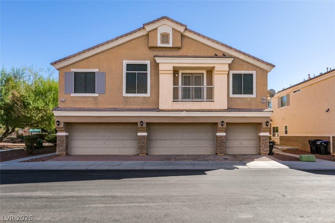 3612 Indigo Flower Street, #2, North Las Vegas, NV 89084 Stucco exterior walls paired with a tile roof define this two-story residential building design.