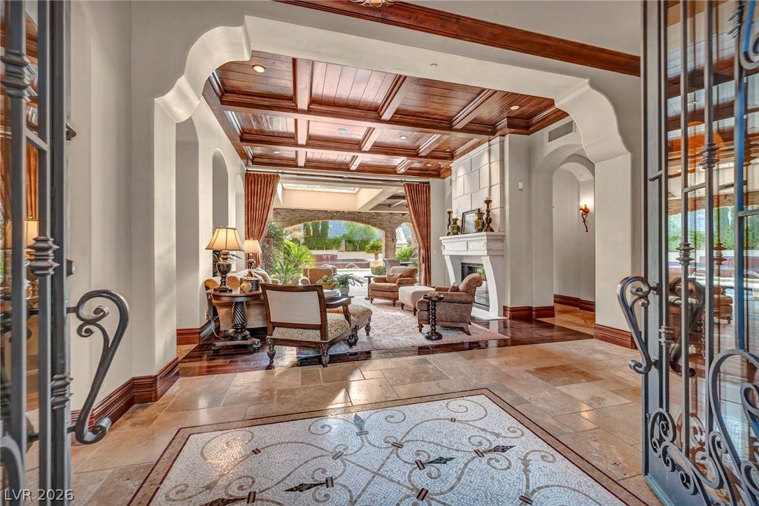 1793 Anelli Court, Henderson, NV 89012 A magnificent entryway with custom mosaic tile flooring leads into a fireplace-warmed living room.