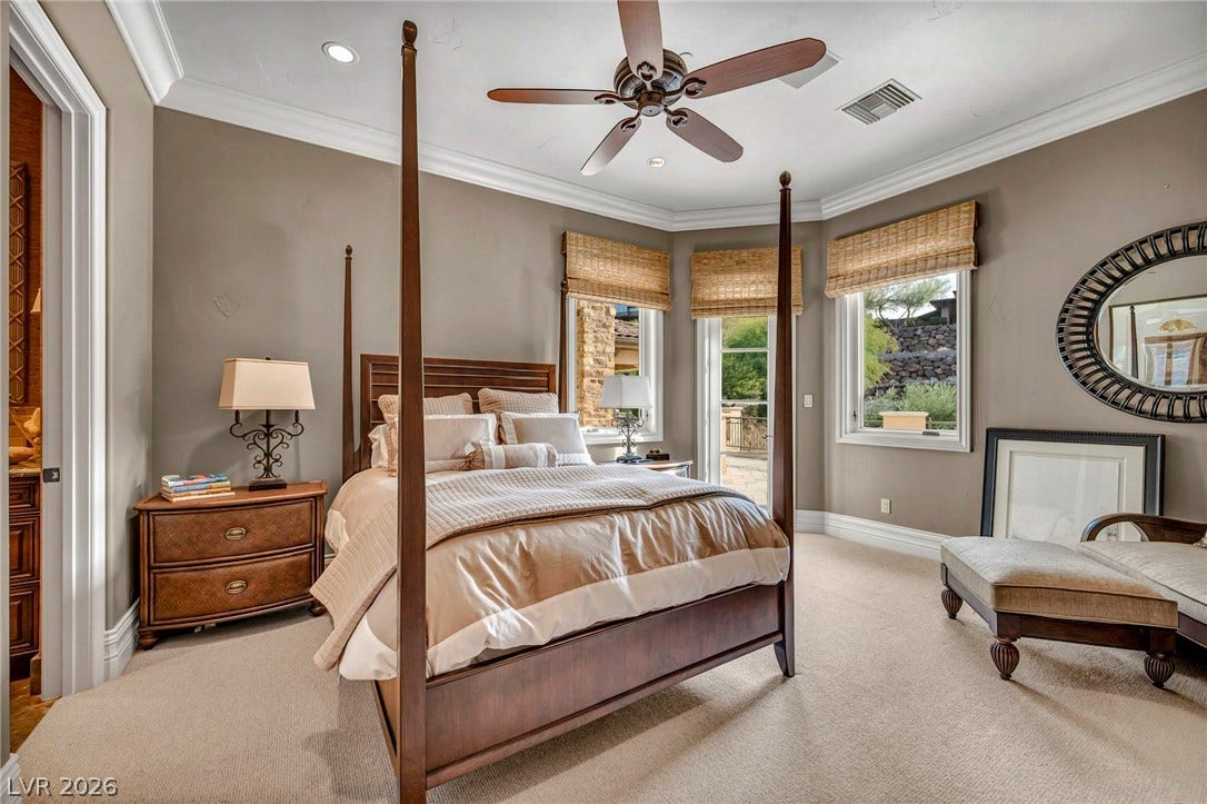 1793 Anelli Court, Henderson, NV 89012 Elegant crown molding and plush carpet ground this quiet bedroom retreat with outdoor access.