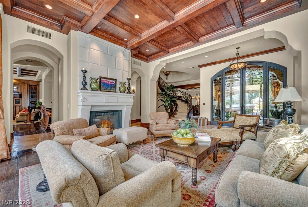 1793 Anelli Court, Henderson, NV 89012 Rich wood-coffered ceilings and a stone fireplace anchor this elegant, light-filled gathering space.