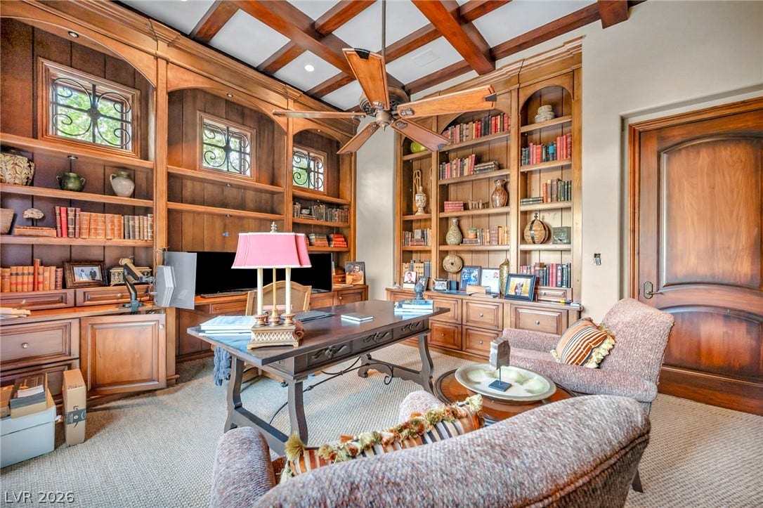 1793 Anelli Court, Henderson, NV 89012 Rich wood paneling and custom built-in bookshelves define this stately home office space.
