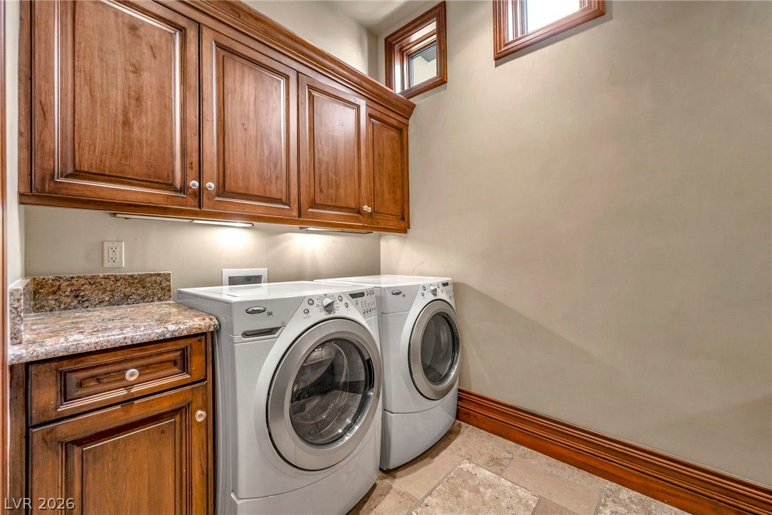 1793 Anelli Court, Henderson, NV 89012 Rich wood cabinetry and stone countertops elevate this highly functional laundry workspace.