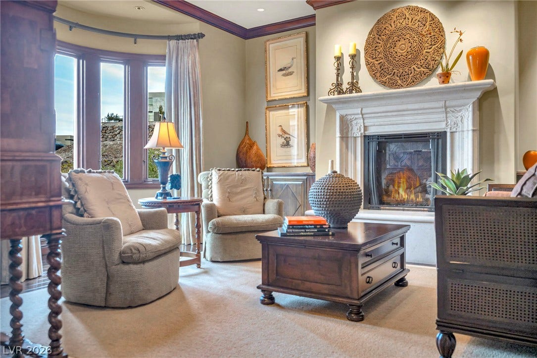 1793 Anelli Court, Henderson, NV 89012 An elegant fireplace with an ornate mantel serves as the centerpiece of this inviting room.