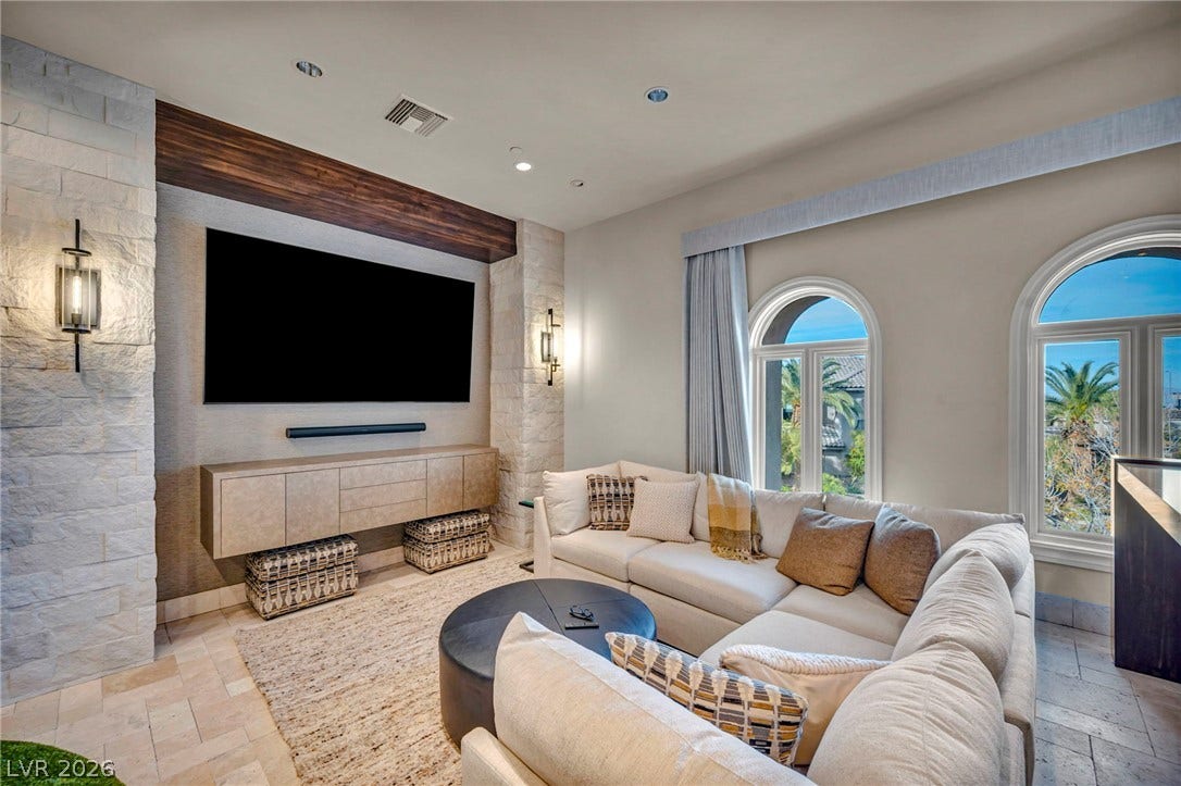 1793 Anelli Court, Henderson, NV 89012 Arched windows and stone-clad details elevate this inviting media area.