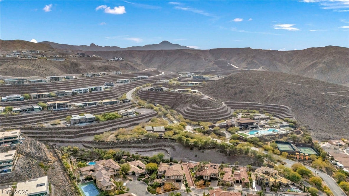 1793 Anelli Court, Henderson, NV 89012 Dramatic mountain ridges frame this master-planned desert community with terraced hillsides under vast blue skies.