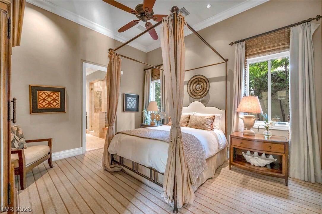 1793 Anelli Court, Henderson, NV 89012 High ceilings, custom crown molding, and plush carpeting elevate this serene primary bedroom.