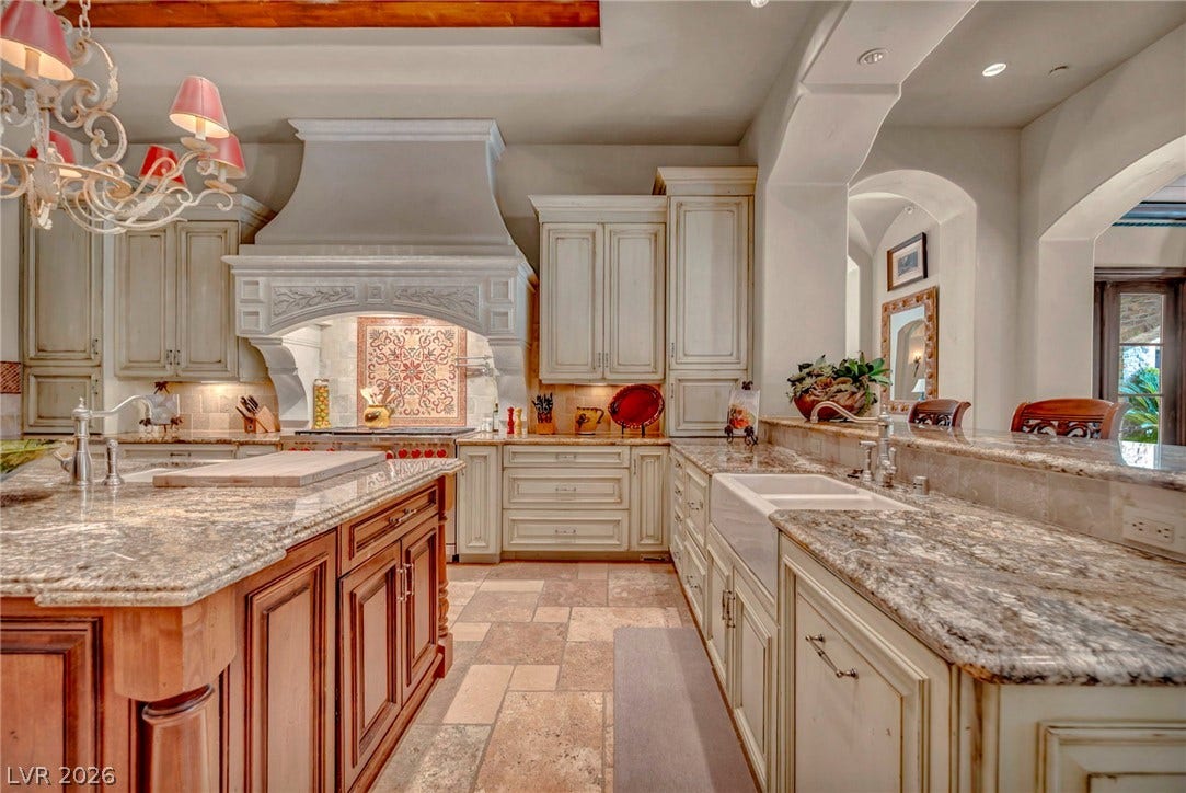 1793 Anelli Court, Henderson, NV 89012 Gleaming stone countertops and rustic tile floors define this richly detailed kitchen space.