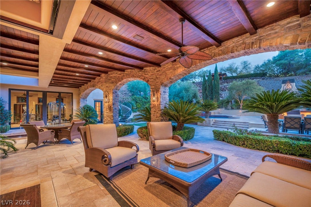 1793 Anelli Court, Henderson, NV 89012 Stone arches and a wood-paneled ceiling frame this sheltered terrace overlooking the pool.