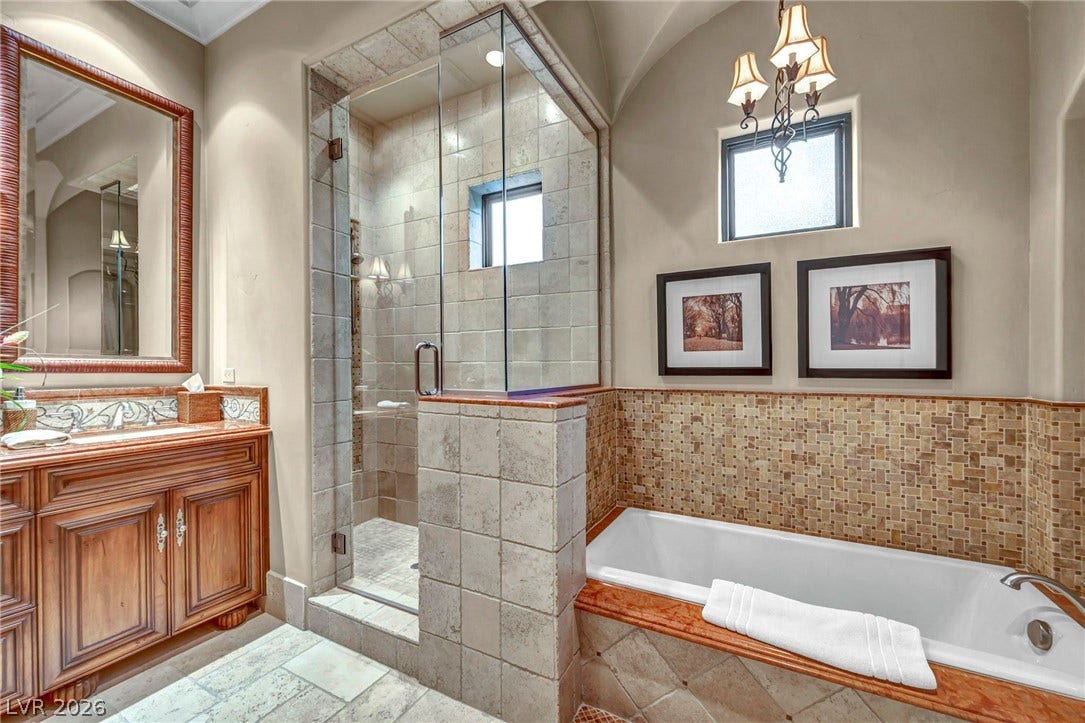 1793 Anelli Court, Henderson, NV 89012 Tiled accents, a walk-in shower, and a soaking tub create a refined main bath retreat.