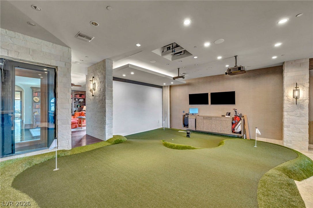 1793 Anelli Court, Henderson, NV 89012 Stone pillars frame an indoor putting green beneath a modern recessed lighting system.