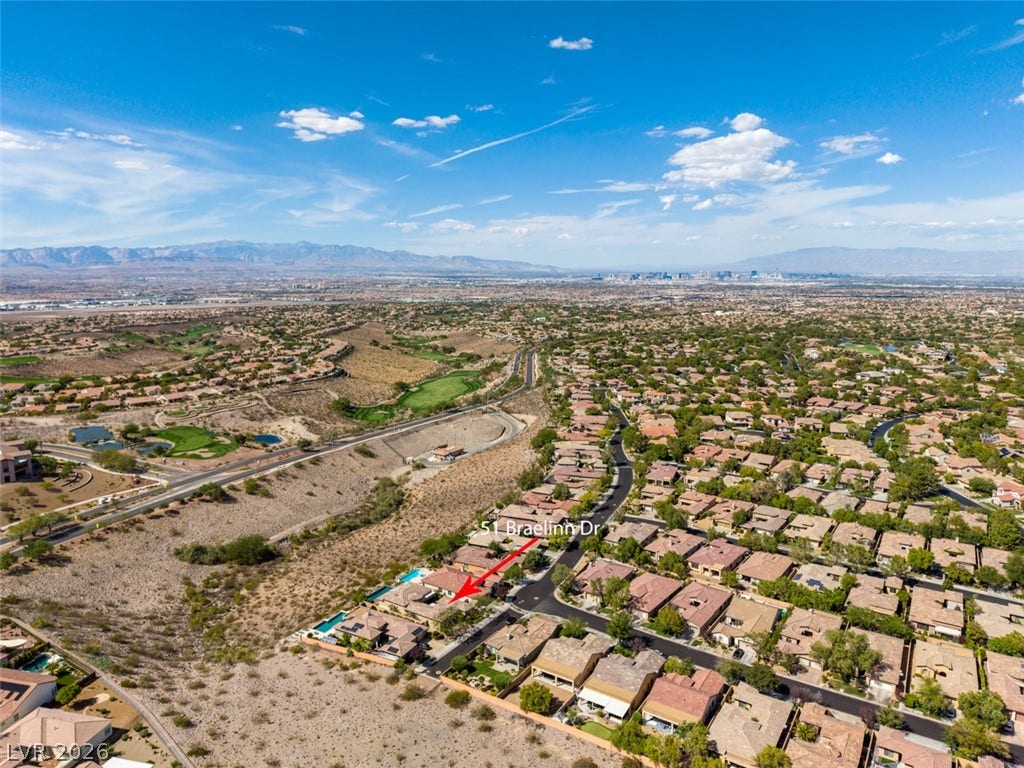 51 E Braelinn Drive, Henderson, NV 89052 An aerial perspective showcases the sweeping mountain and valley views surrounding this hillside neighborhood.
