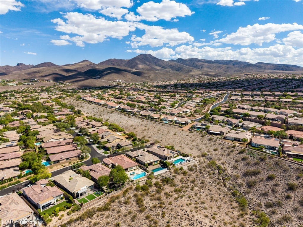 51 E Braelinn Drive, Henderson, NV 89052 Dramatic mountain ridges frame a vast residential neighborhood under a bright desert sky.