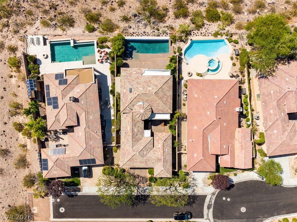 51 E Braelinn Drive, Henderson, NV 89052 Aerial view reveals tiled roofs, private swimming pools, and desert landscaping lining a quiet street.