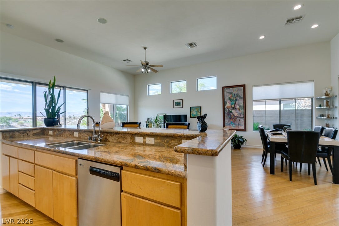 51 E Braelinn Drive, Henderson, NV 89052 Gleaming wood floors and premium stone countertops define this inviting, open-concept living space.