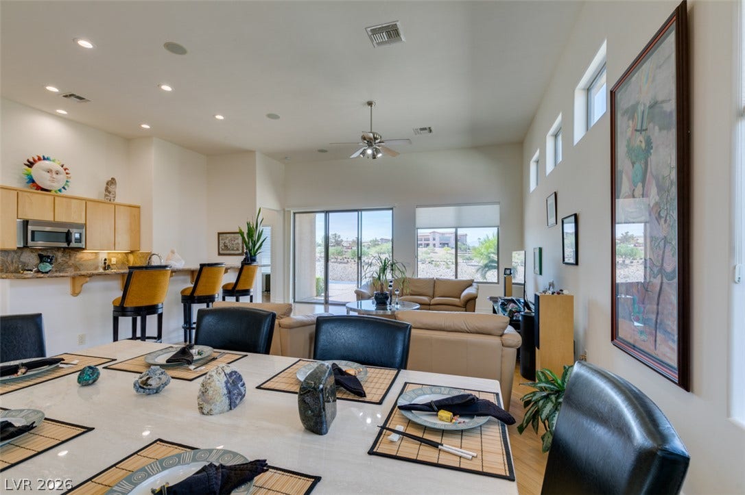 51 E Braelinn Drive, Henderson, NV 89052 An open floor plan connects the dining area to a living space under high ceilings.