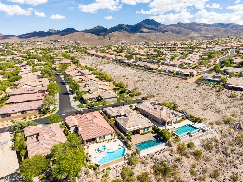 51 E Braelinn Drive, Henderson, NV 89052 Dramatic mountain vistas frame this peaceful neighborhood of single-story homes with backyard pools.