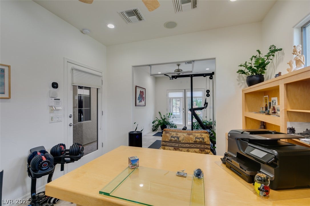 51 E Braelinn Drive, Henderson, NV 89052 Gleaming hardwood floors and recessed lighting enhance this versatile home office and gym space.