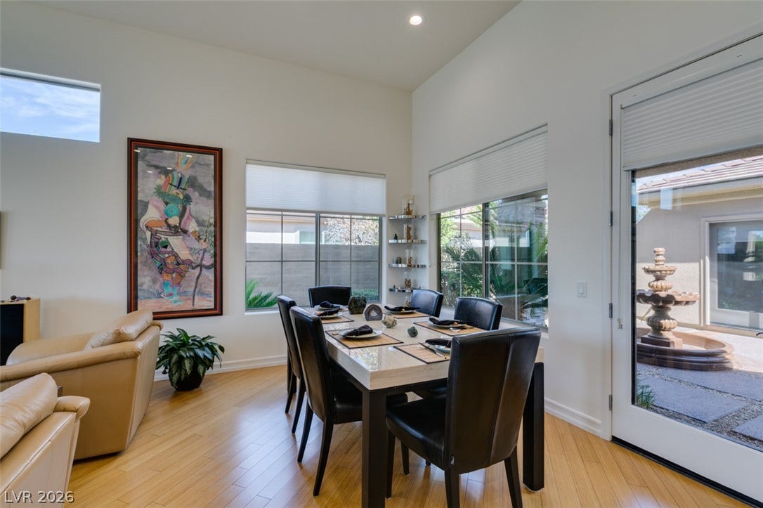 51 E Braelinn Drive, Henderson, NV 89052 Gleaming wood floors and towering ceilings highlight this inviting dining space bordering a sunlit courtyard.