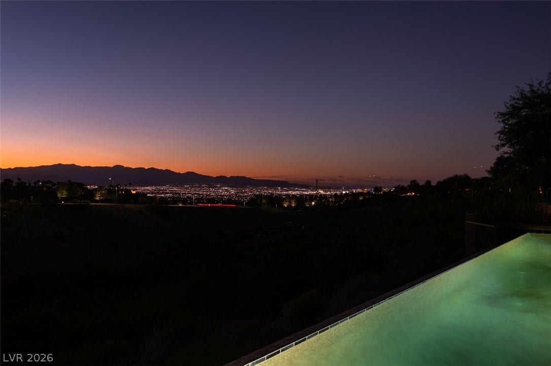 51 E Braelinn Drive, Henderson, NV 89052 Glittering city lights and distant mountains unfold from the edge of a hillside pool.