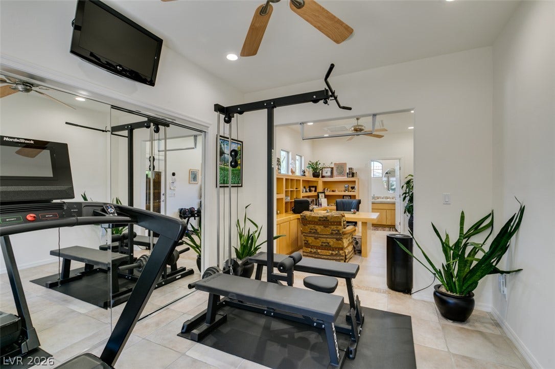 51 E Braelinn Drive, Henderson, NV 89052 An open archway connects the tiled home fitness space directly to a private study.