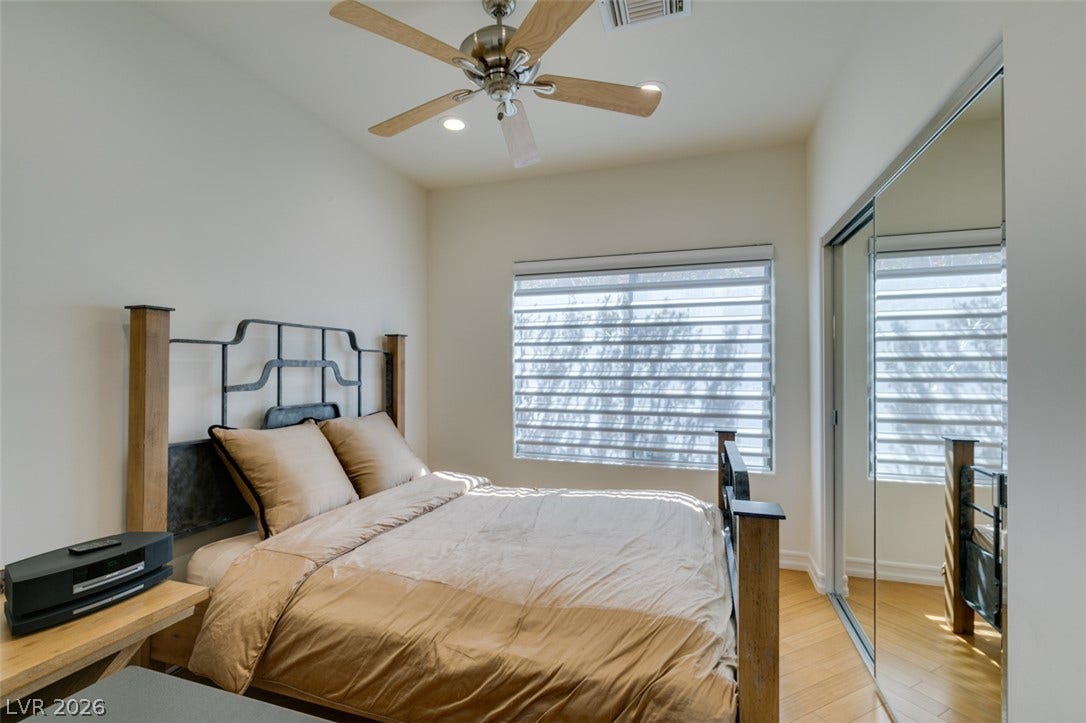 51 E Braelinn Drive, Henderson, NV 89052 Gleaming hardwood floors and a mirrored closet maximize natural light in this quiet bedroom.