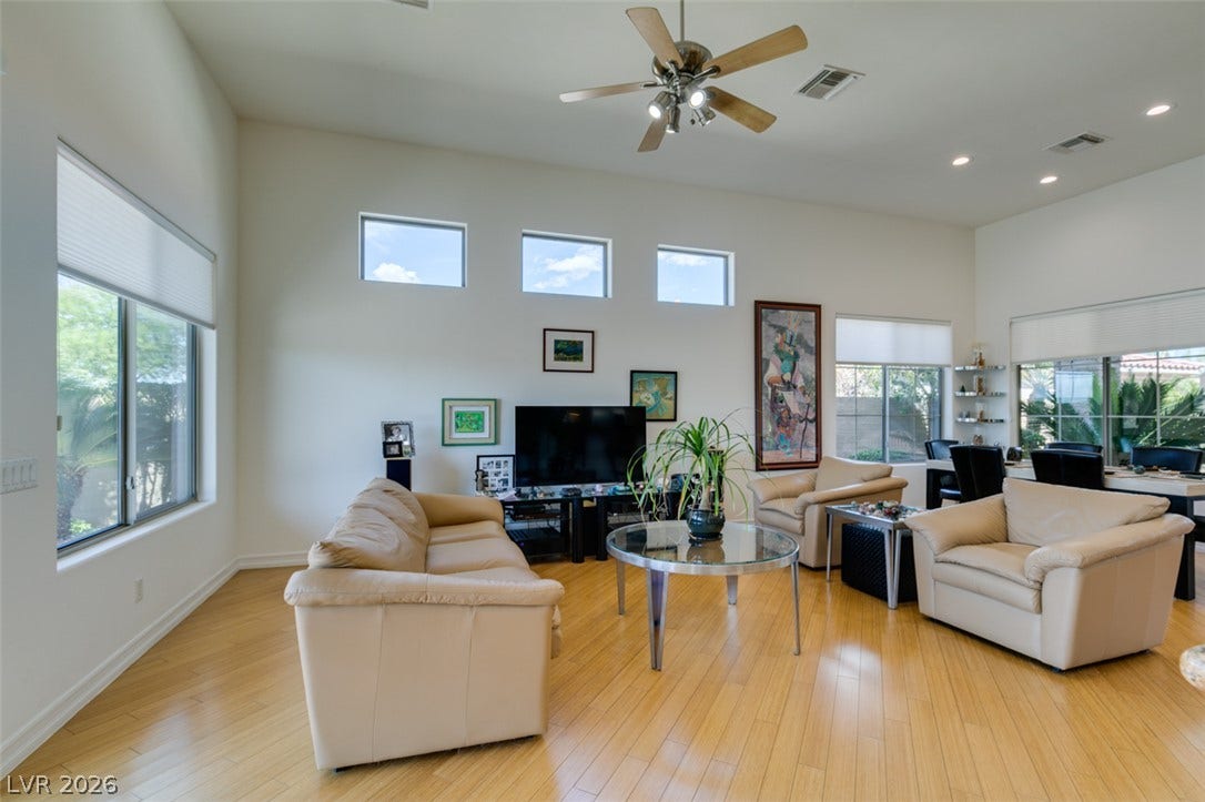 51 E Braelinn Drive, Henderson, NV 89052 High ceilings and gleaming wood floors define this open living space.