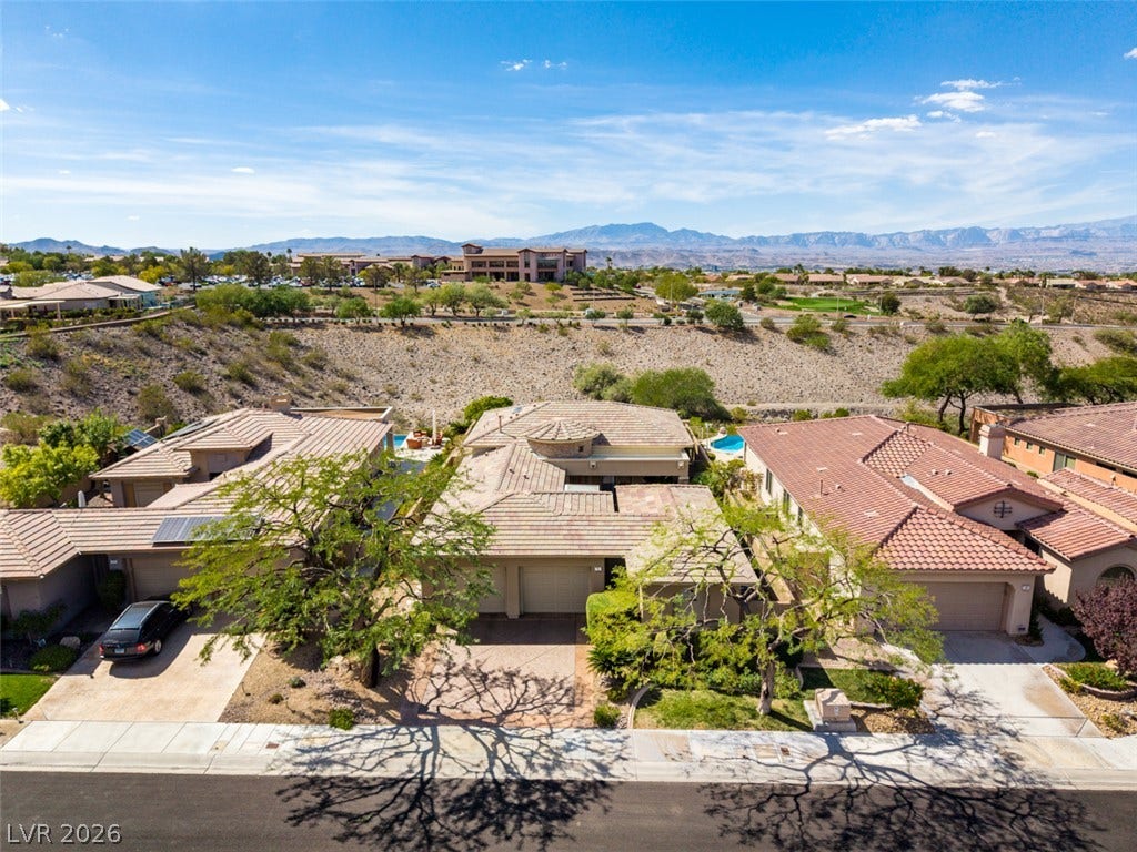 51 E Braelinn Drive, Henderson, NV 89052 Expansive desert vistas and mountain backdrops frame these elegant tile-roofed residences.
