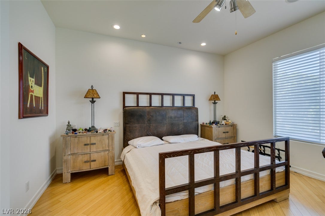 51 E Braelinn Drive, Henderson, NV 89052 Gleaming hardwood floors and recessed lighting enhance this airy bedroom.