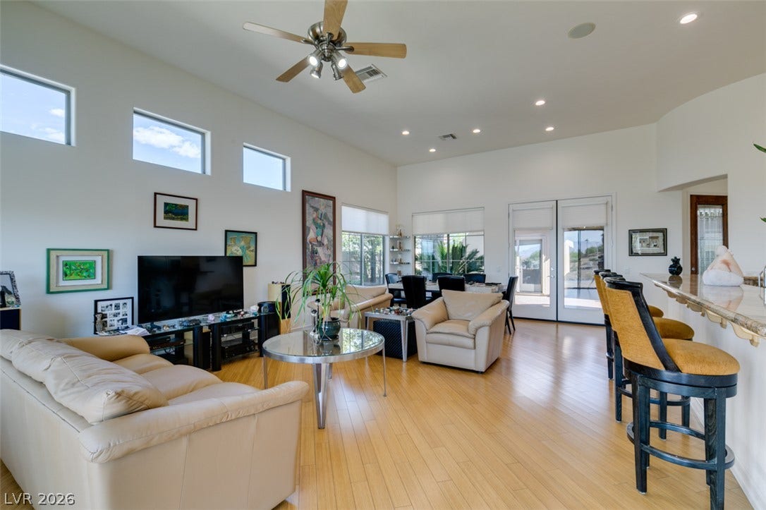 51 E Braelinn Drive, Henderson, NV 89052 Gleaming hardwood floors and high ceilings define this open main living space.