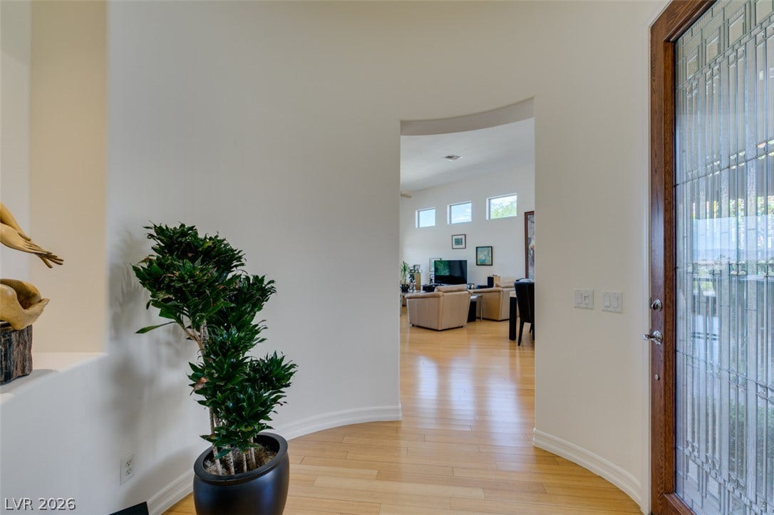 51 E Braelinn Drive, Henderson, NV 89052 Polished wood floors and a curved entryway design lead directly into the open living areas.