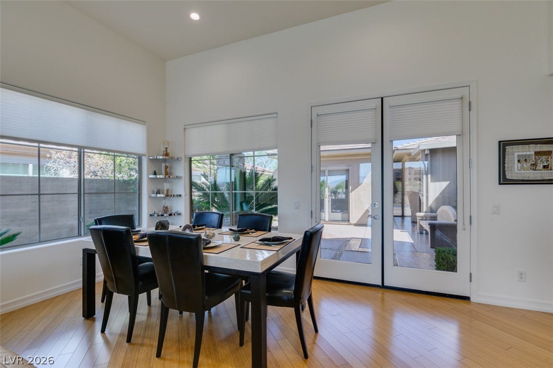 51 E Braelinn Drive, Henderson, NV 89052 Gleaming hardwood floors and high ceilings elevate this inviting dining space with terrace access.