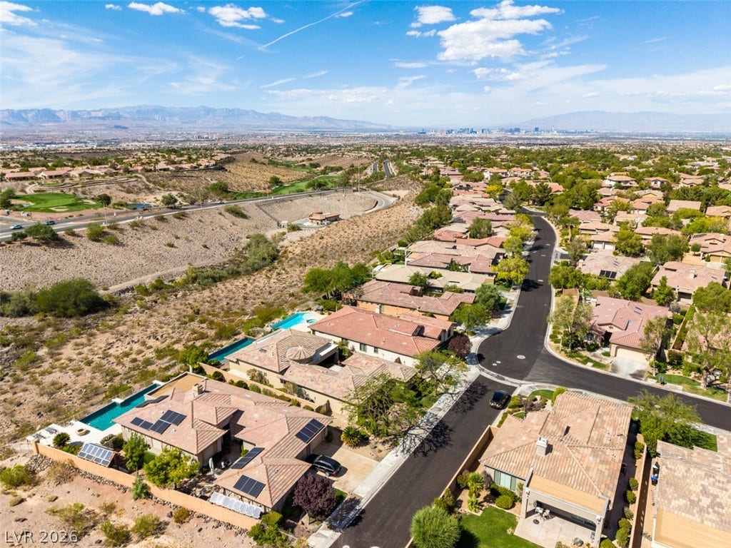 51 E Braelinn Drive, Henderson, NV 89052 A neighborhood street winds past desert-landscaped yards under a vast sky.
