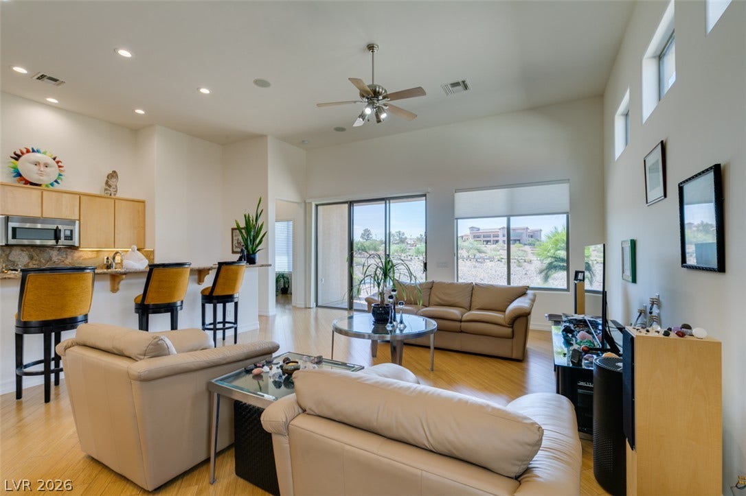 51 E Braelinn Drive, Henderson, NV 89052 High ceilings and gleaming wood flooring define this open living area with sliding doors.