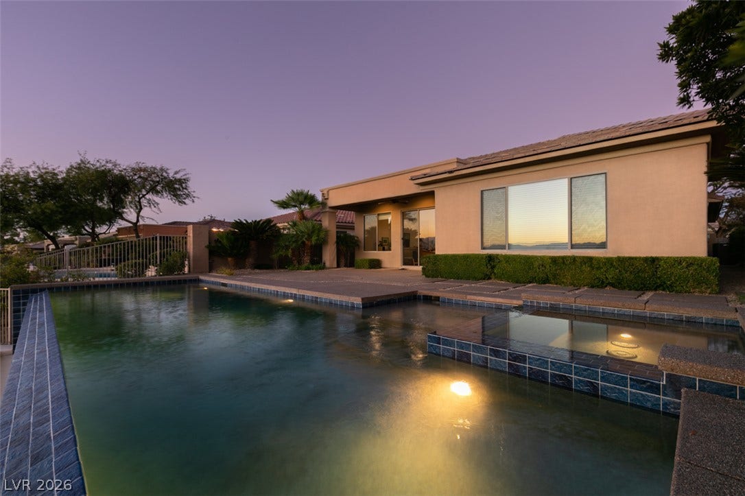 51 E Braelinn Drive, Henderson, NV 89052 An inviting backyard oasis centers around a custom swimming pool and integrated spa.