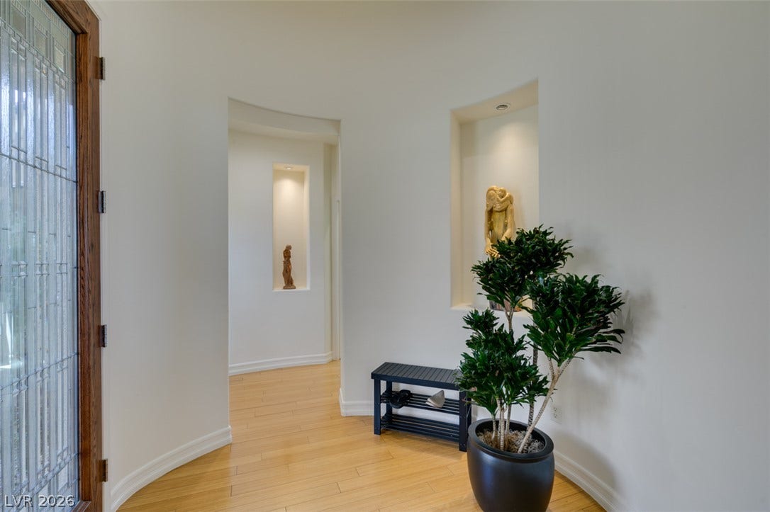 51 E Braelinn Drive, Henderson, NV 89052 Curving architectural walls and polished wood floors welcome guests into this elegant entryway.