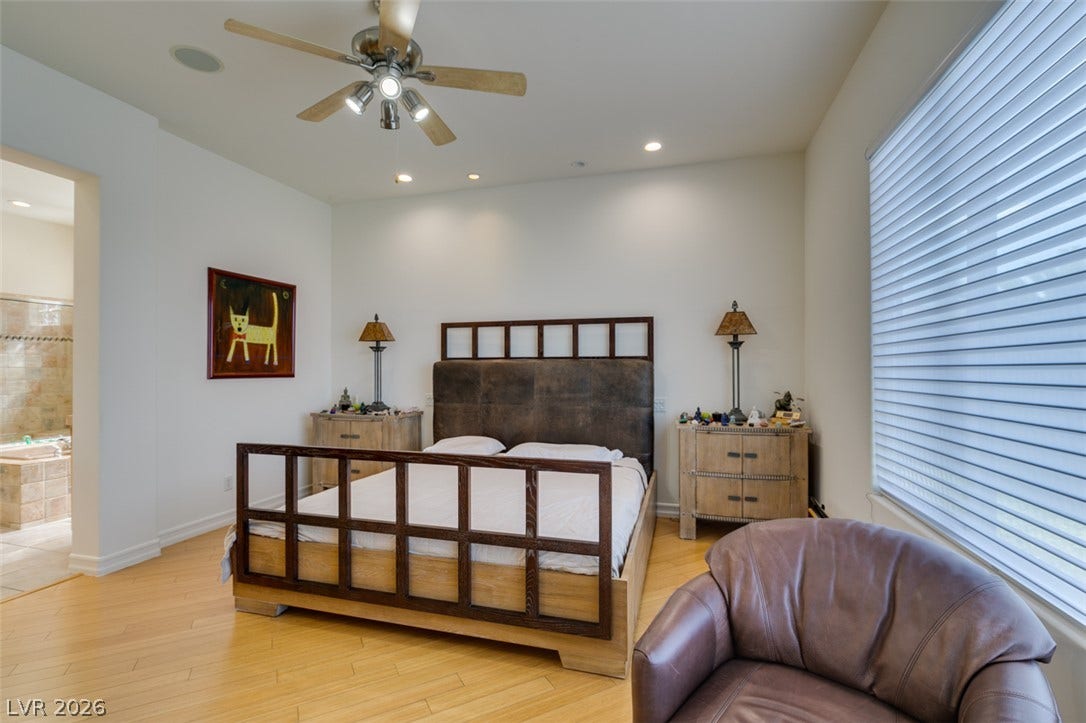 51 E Braelinn Drive, Henderson, NV 89052 Hardwood floors and recessed lighting anchor this inviting primary suite.