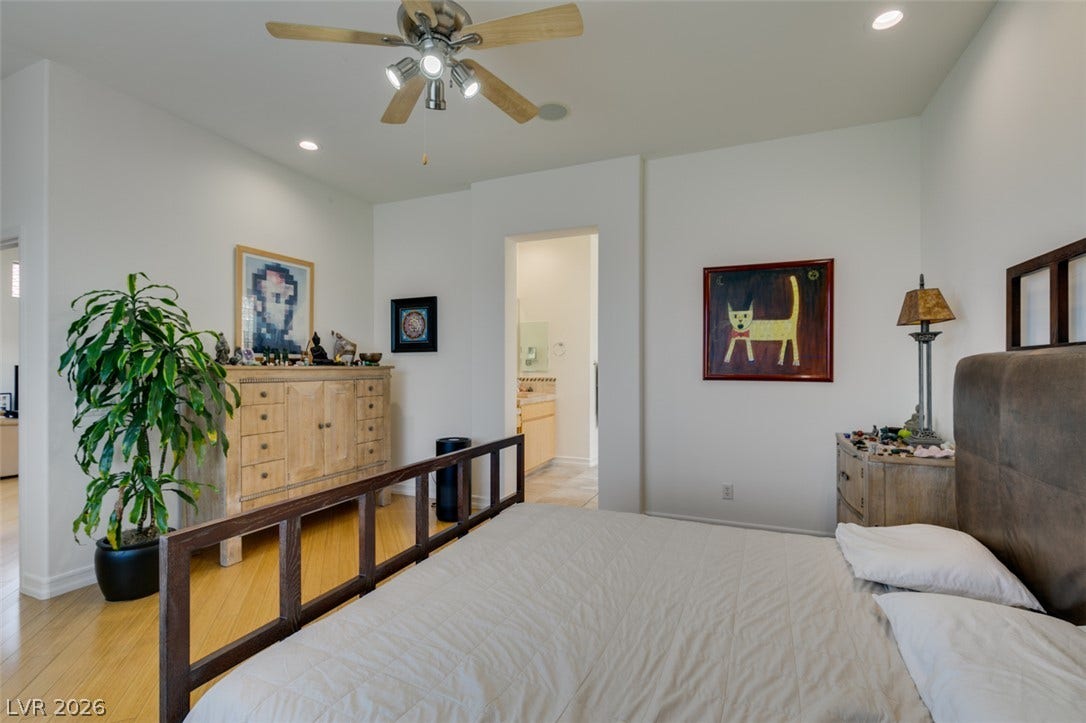 51 E Braelinn Drive, Henderson, NV 89052 Gleaming hardwood floors and recessed lighting enhance this peaceful bedroom with an adjoining bath.