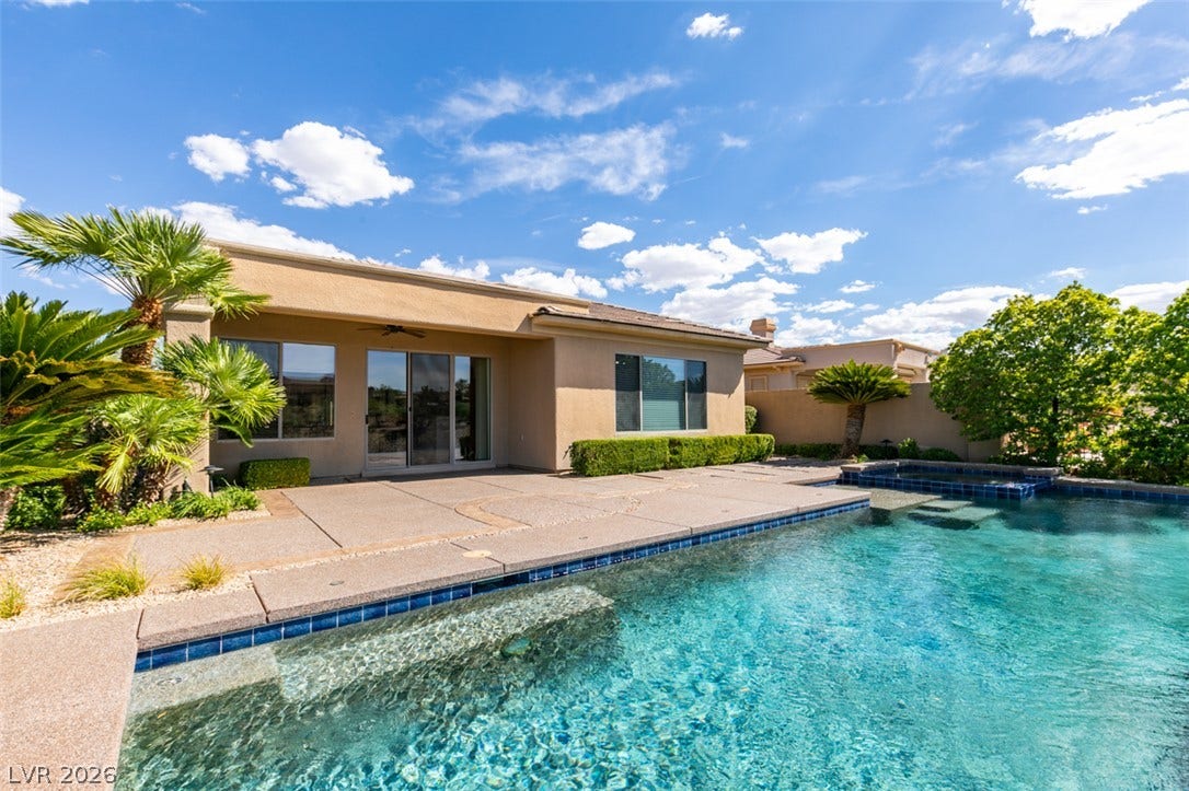 51 E Braelinn Drive, Henderson, NV 89052 An inviting backyard oasis features a pristine swimming pool and concrete patio decking.