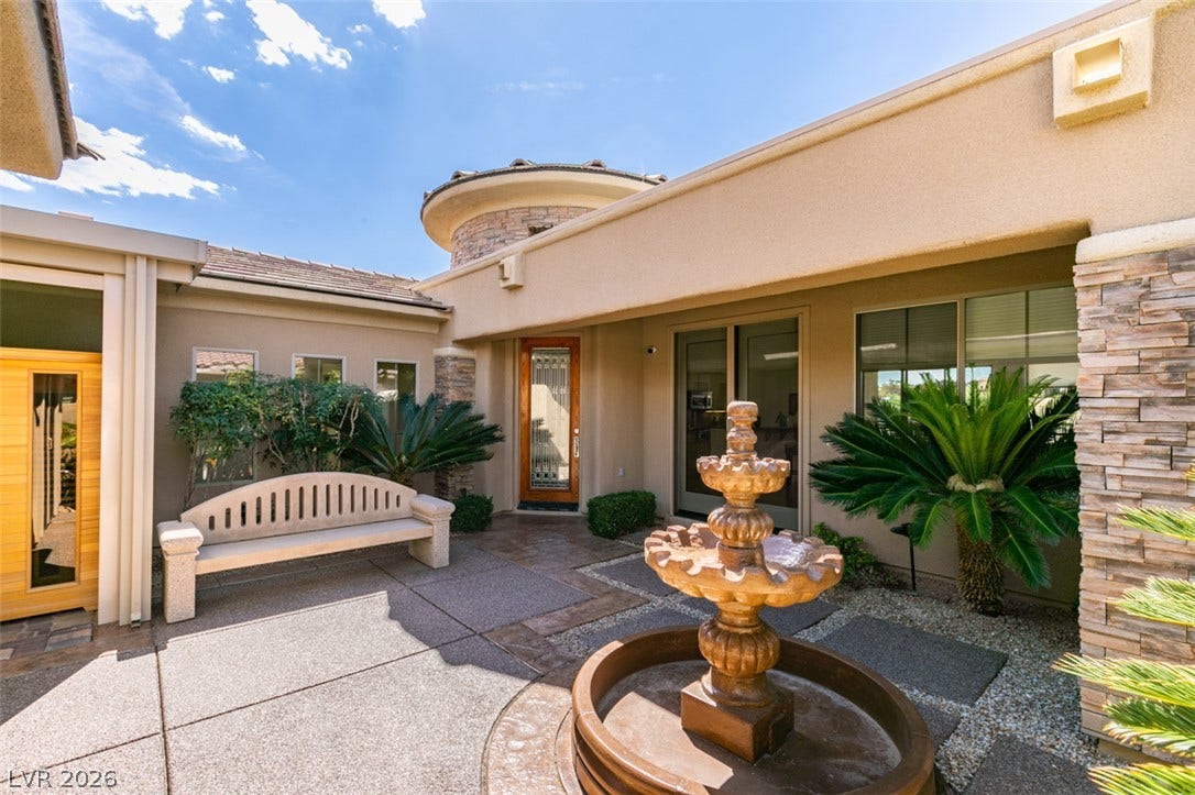 51 E Braelinn Drive, Henderson, NV 89052 An inviting courtyard entrance features stone accents and a classic tiered fountain.