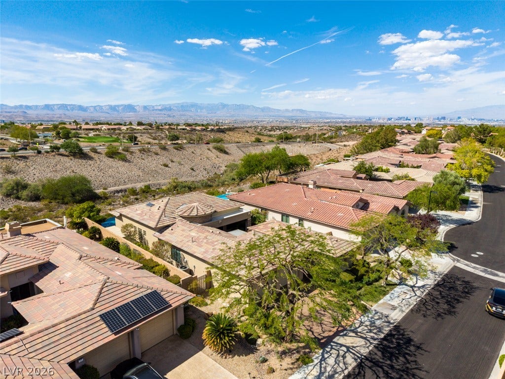 51 E Braelinn Drive, Henderson, NV 89052 Distant mountain ranges and city skyline views frame this suburban neighborhood setting.